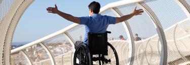 Manual wheelchair Küschall Champion black frame man on the bridge