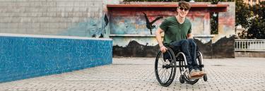 Manual wheelchair Küschall K-Series young man on the street