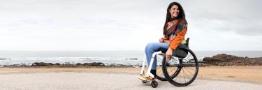 The KSL manual wheelchair white frame woman on the beach